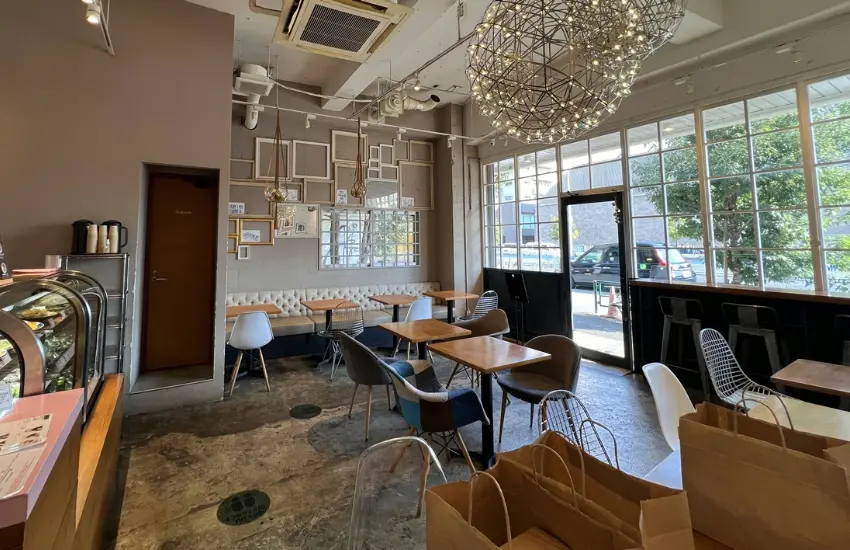 ▲店內設計為偏北歐簡約風,木質桌椅、白牆與大片落地窗。