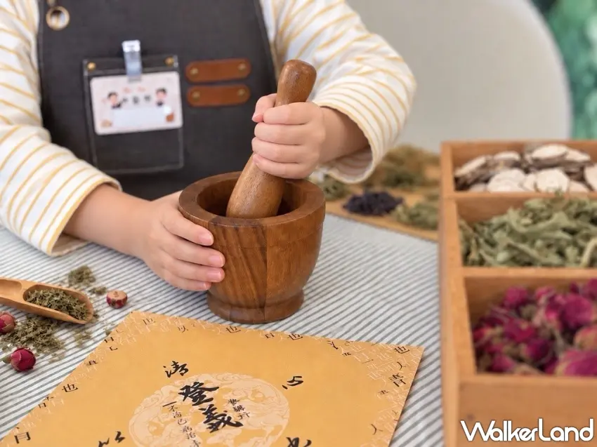 ▲小手拿起藥杵認真搗製草本,旁邊擺滿不同植物素材,透過聞香、觸摸到親手製作,把原本陌生的漢方知識變成可以實際參與的五感體驗。圖/捷絲旅提供;窩客島整理